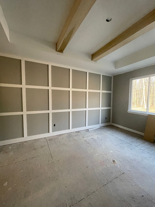 unfurnished room featuring beamed ceiling