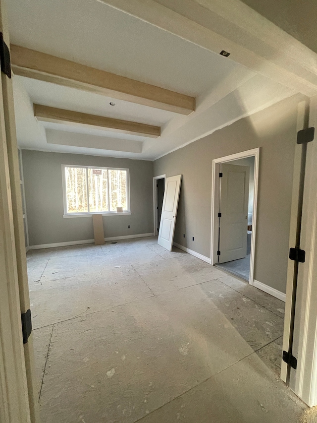 interior space with beamed ceiling and baseboards