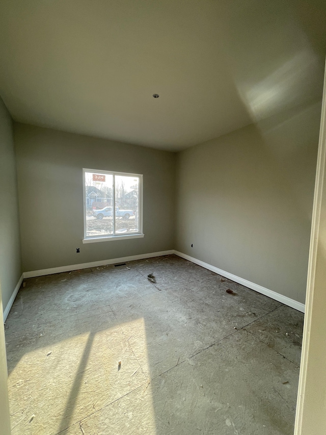 empty room featuring baseboards