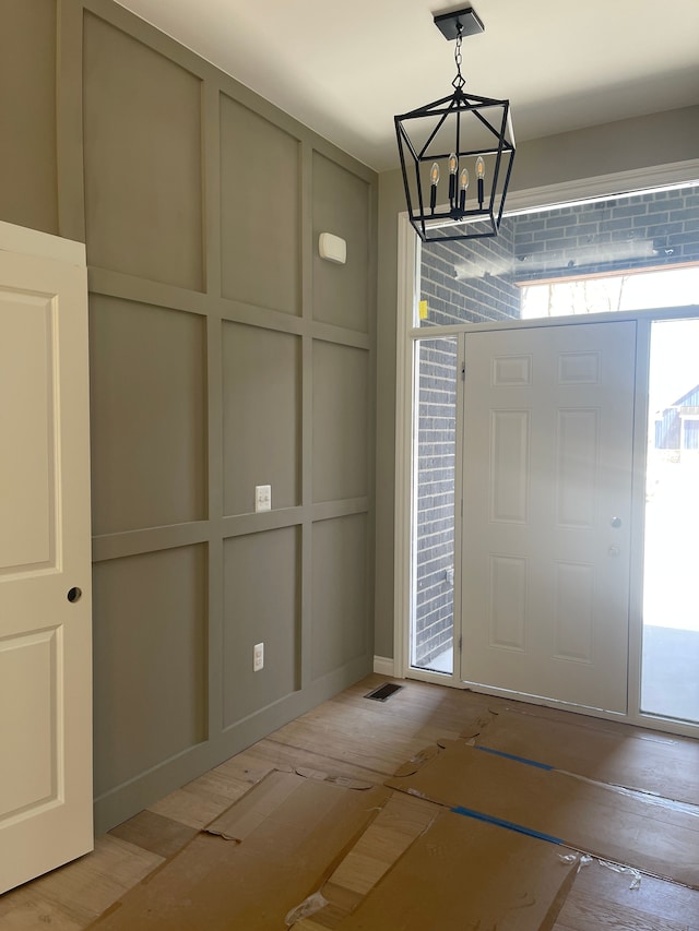 foyer entrance with a chandelier