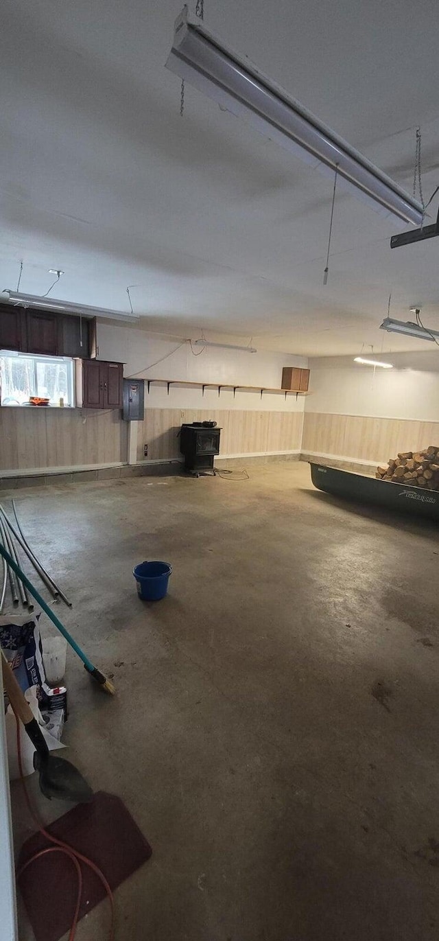 garage featuring electric panel and wooden walls