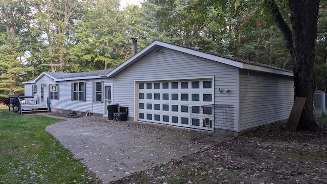 exterior space with a garage and a wooden deck