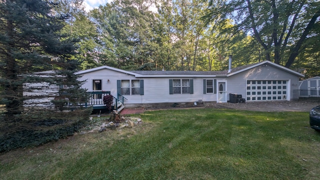 view of front of house with a garage and a front lawn