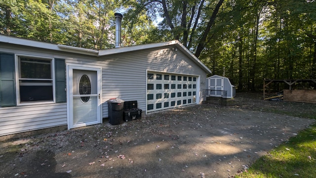 view of side of property with a shed and a garage