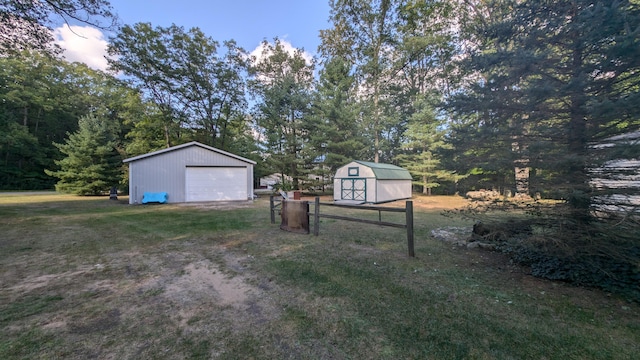 yard at dusk featuring a garage and a storage unit