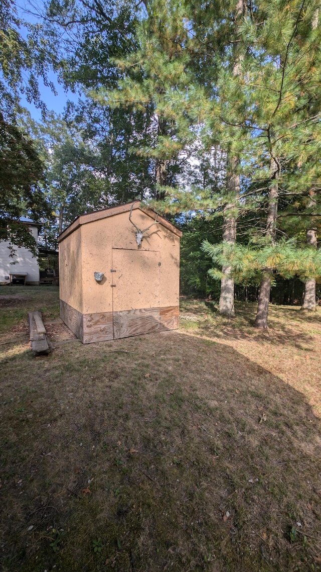 view of outbuilding featuring a lawn