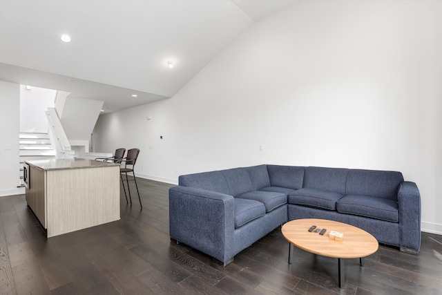 living room with dark wood-type flooring and lofted ceiling