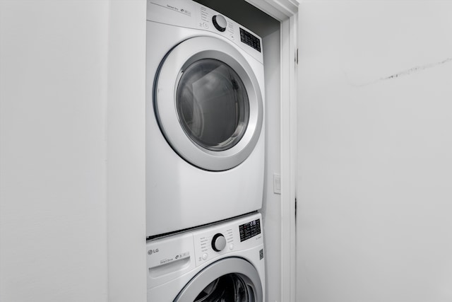 washroom with stacked washer and clothes dryer