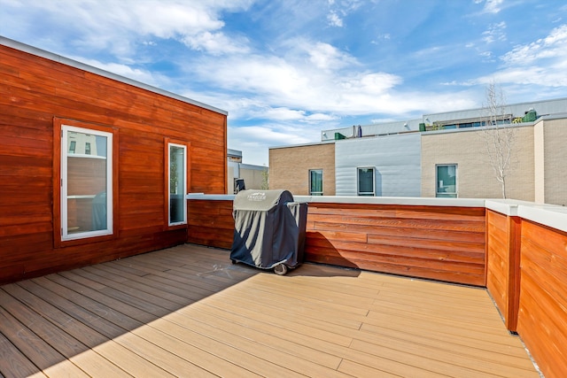 wooden deck featuring a grill