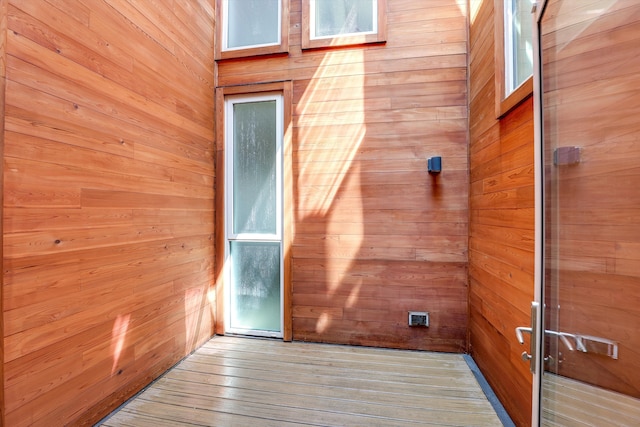 interior space featuring hardwood / wood-style flooring and wood walls