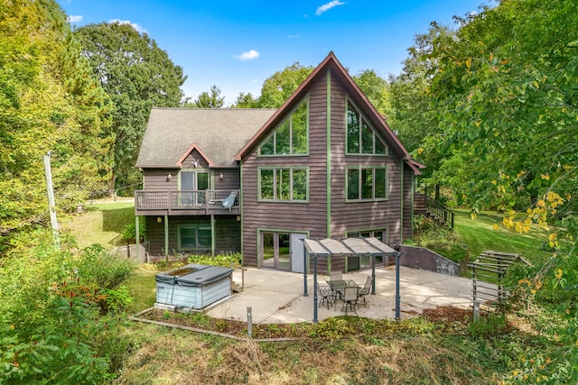 back of house with a patio and a hot tub