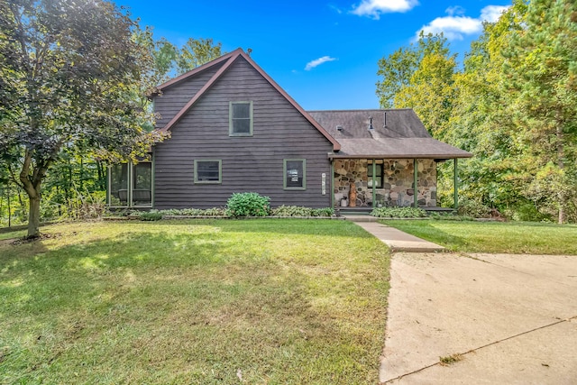 view of property with covered porch and a front lawn