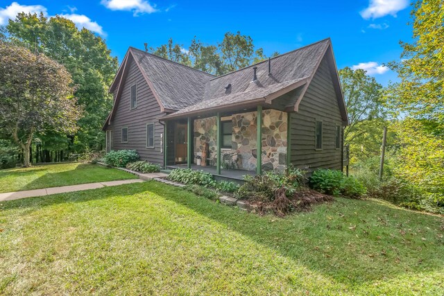 2488 Wilson St, Hillsdale, MI 49242 - view of front of home with a front lawn, stone siding, and roof with shingles