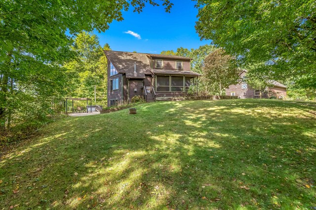 2488 Wilson St, Hillsdale, MI 49242 - view of grassy yard with a sunroom