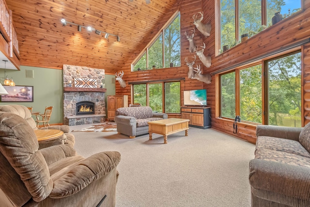 carpeted living room with rail lighting, wood ceiling, a fireplace, and high vaulted ceiling
