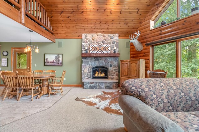 2488 Wilson St, Hillsdale, MI 49242 - living room with high vaulted ceiling, log walls, wooden ceiling, a fireplace, and baseboards
