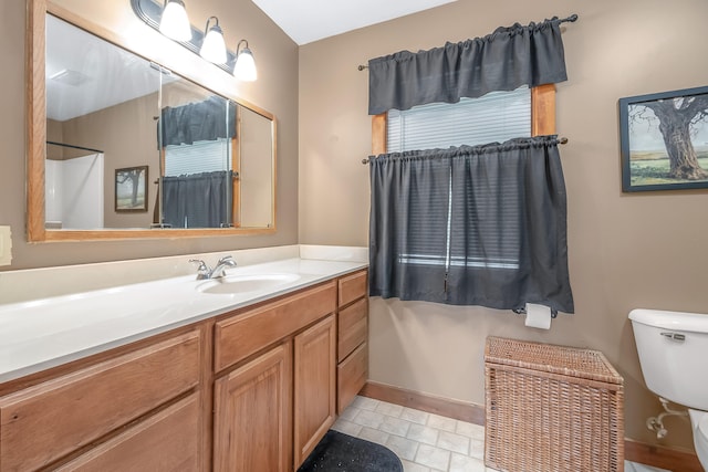 bathroom with tile patterned floors, vanity, and toilet
