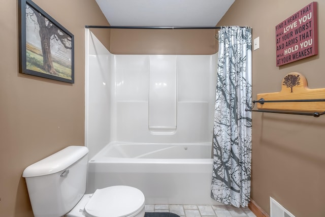 bathroom with shower / bath combo and toilet