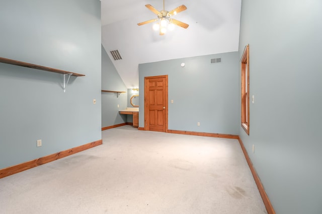 unfurnished living room featuring light carpet, high vaulted ceiling, and ceiling fan