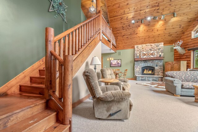 2488 Wilson St, Hillsdale, MI 49242 - carpeted living room with high vaulted ceiling, wooden ceiling, baseboards, stairway, and a fireplace