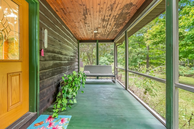 unfurnished sunroom with wooden ceiling