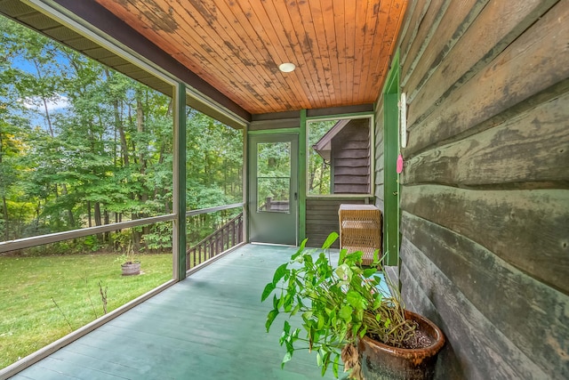 unfurnished sunroom with wood ceiling