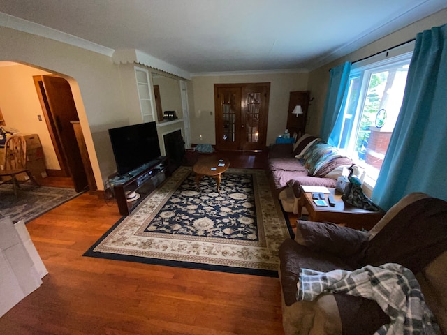 living room featuring crown molding and wood-type flooring