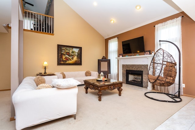 carpeted living room with a tile fireplace, high vaulted ceiling, and ornamental molding