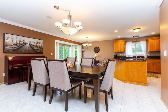 tiled dining space featuring an inviting chandelier, plenty of natural light, and ornamental molding