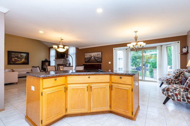 kitchen with a center island, dark stone counters, and a chandelier