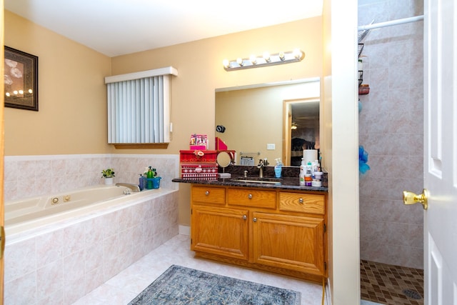 bathroom with tile patterned flooring, vanity, and shower with separate bathtub