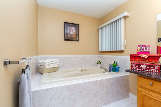 bathroom featuring tile patterned flooring and a relaxing tiled tub