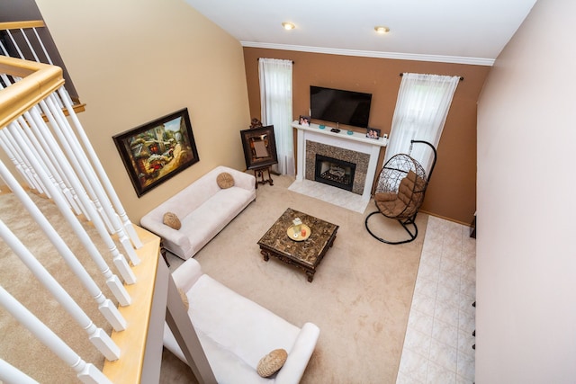 living room featuring crown molding and a fireplace