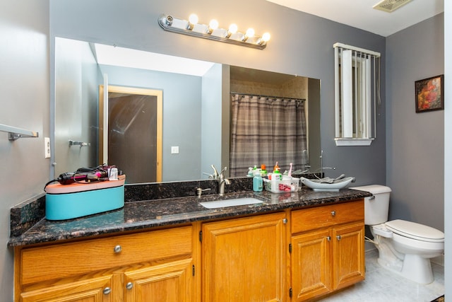 bathroom featuring a shower with curtain, tile patterned flooring, vanity, and toilet