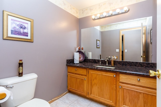 bathroom featuring toilet, vanity, and tile patterned floors