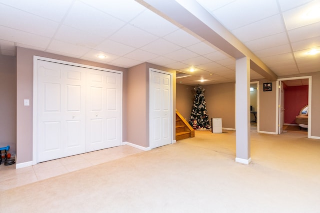 basement with a drop ceiling and carpet floors