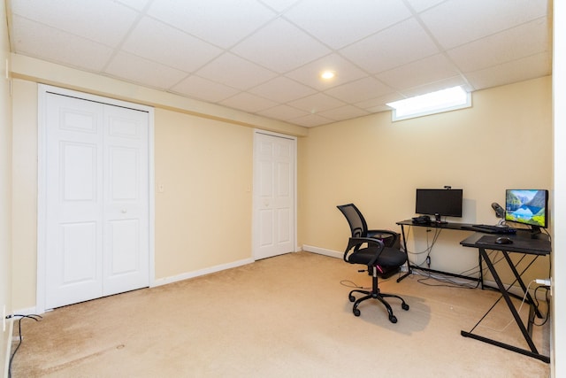 carpeted office with a drop ceiling