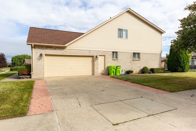 view of side of property featuring a lawn and a garage