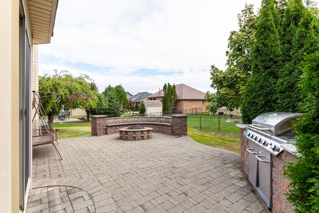 view of patio featuring area for grilling and a fire pit