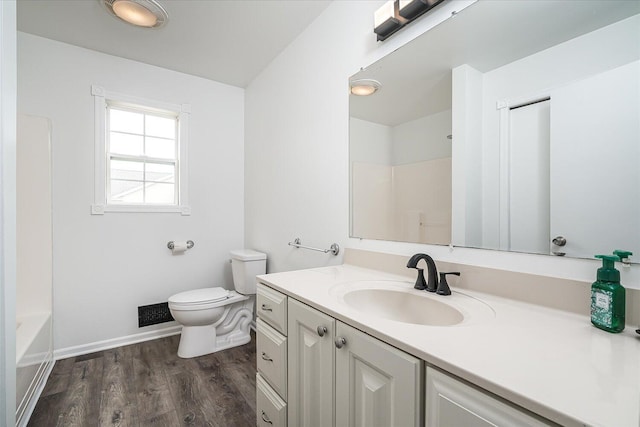 bathroom featuring hardwood / wood-style floors, vanity, and toilet