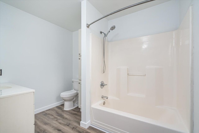 full bathroom featuring vanity, toilet, wood-type flooring, and tub / shower combination