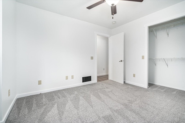 unfurnished bedroom featuring ceiling fan, carpet floors, and a closet