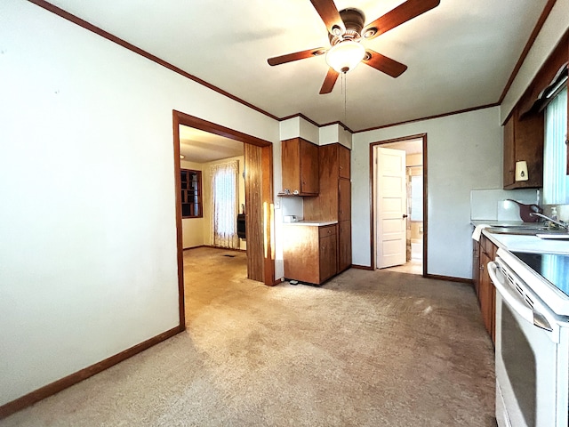 kitchen featuring light carpet, ceiling fan, crown molding, sink, and white electric range