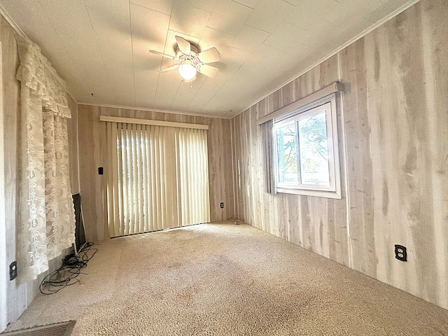 spare room featuring carpet flooring and ceiling fan