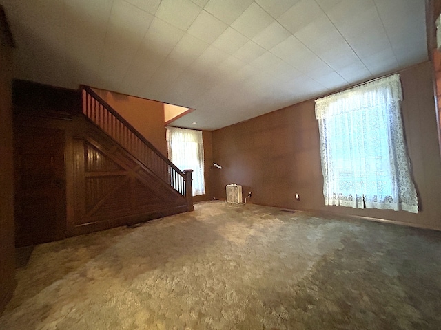 unfurnished living room featuring carpet floors