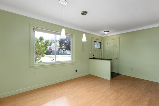 interior space featuring light wood-type flooring and ornamental molding