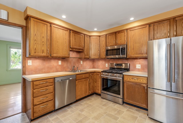 kitchen with sink, decorative backsplash, and appliances with stainless steel finishes