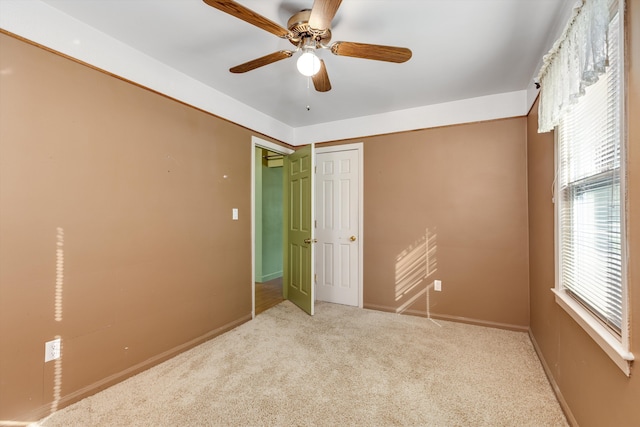 unfurnished bedroom with ceiling fan, a closet, and light carpet