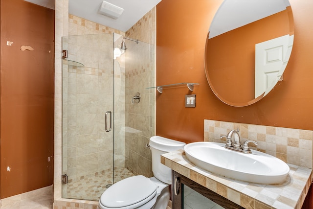 bathroom featuring toilet, a shower with door, tile patterned floors, and sink