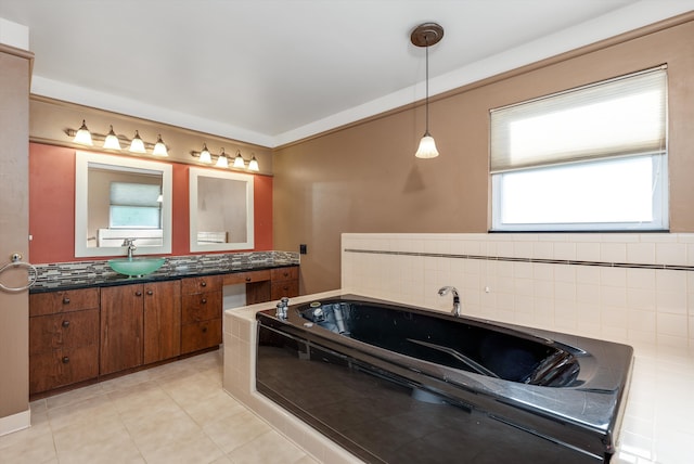 bathroom featuring vanity, tile patterned floors, and a tub to relax in